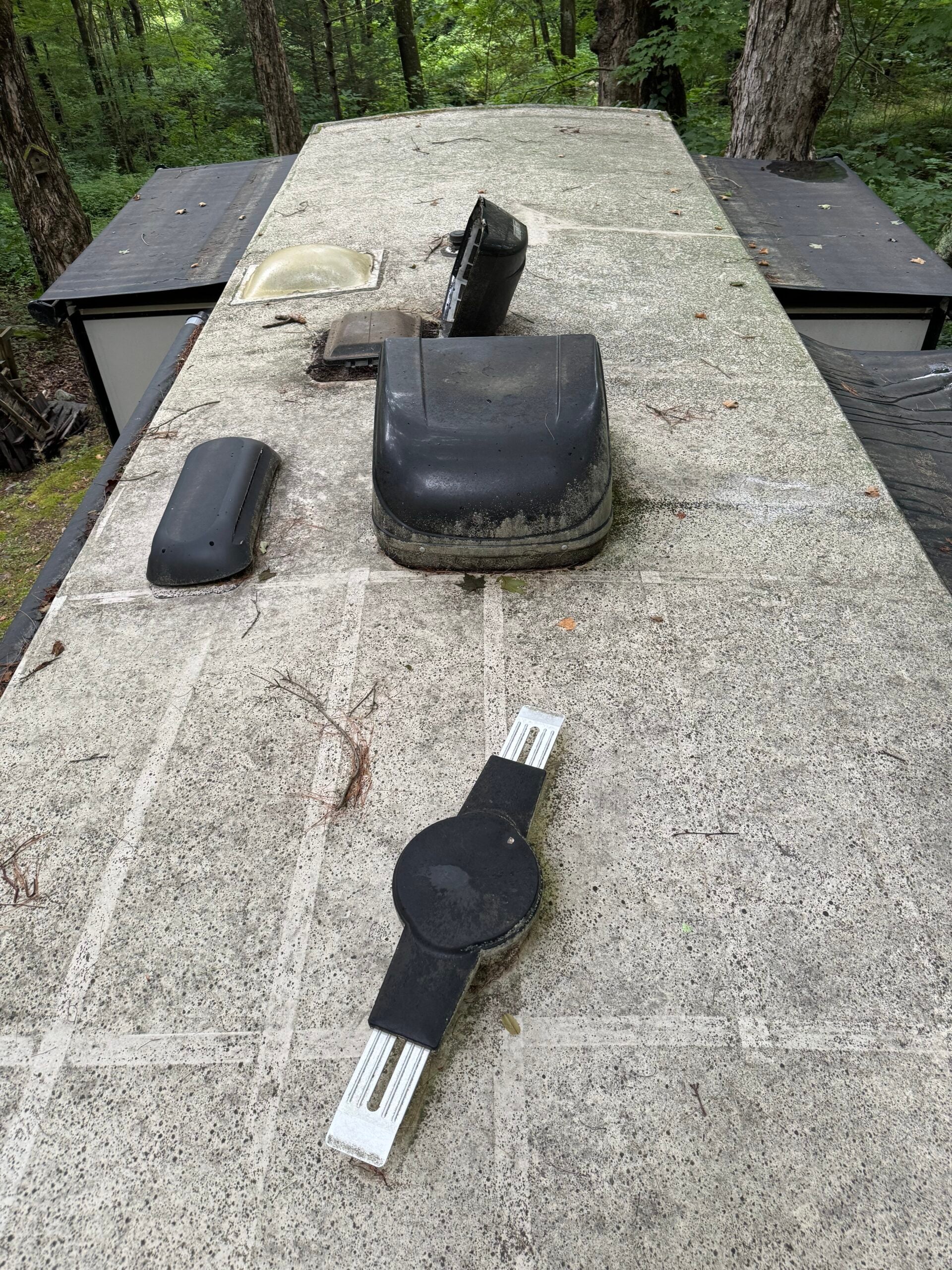 Weathered RV roof before mobile coating service