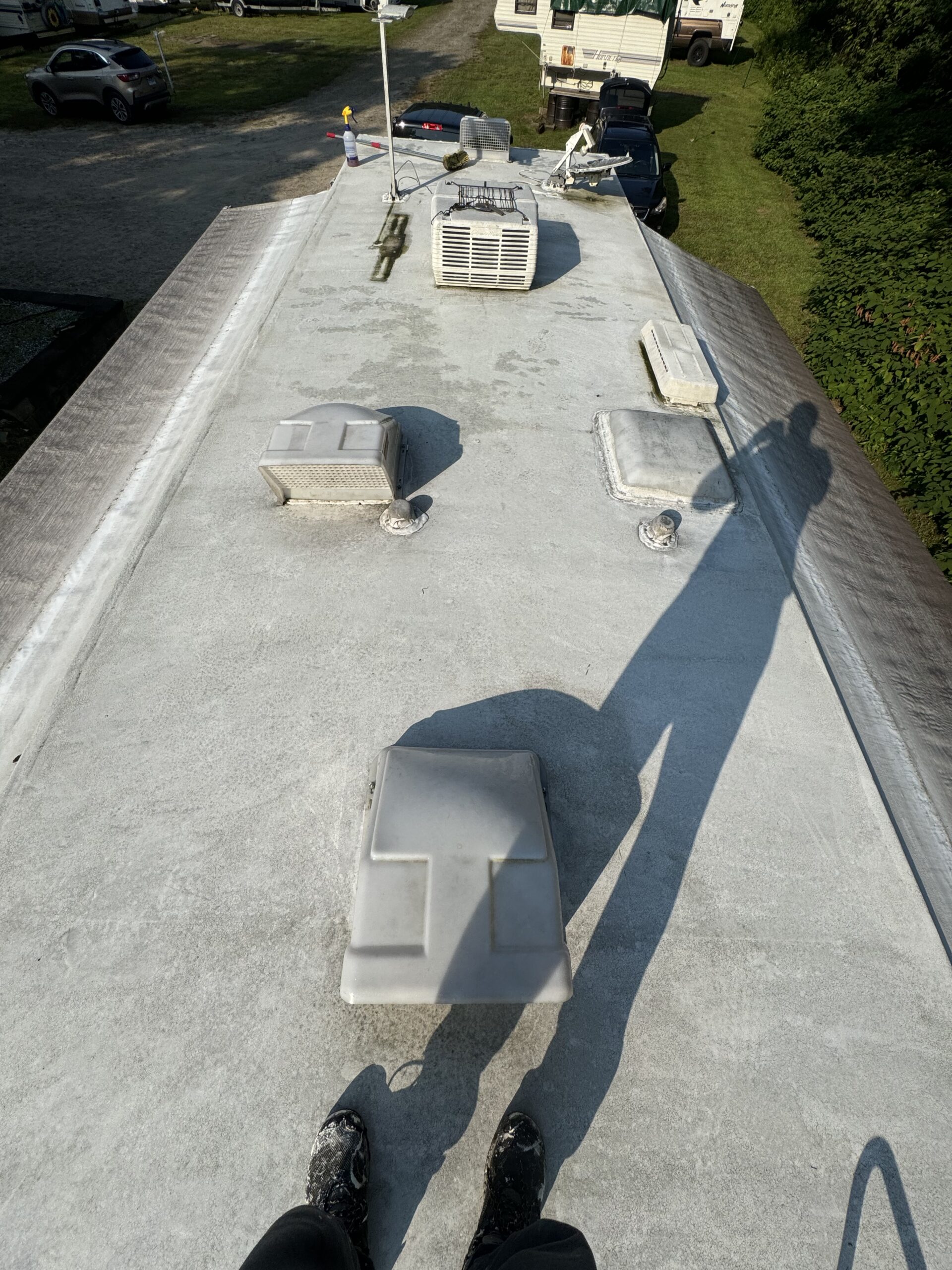 Weathered RV roof before mobile coating service