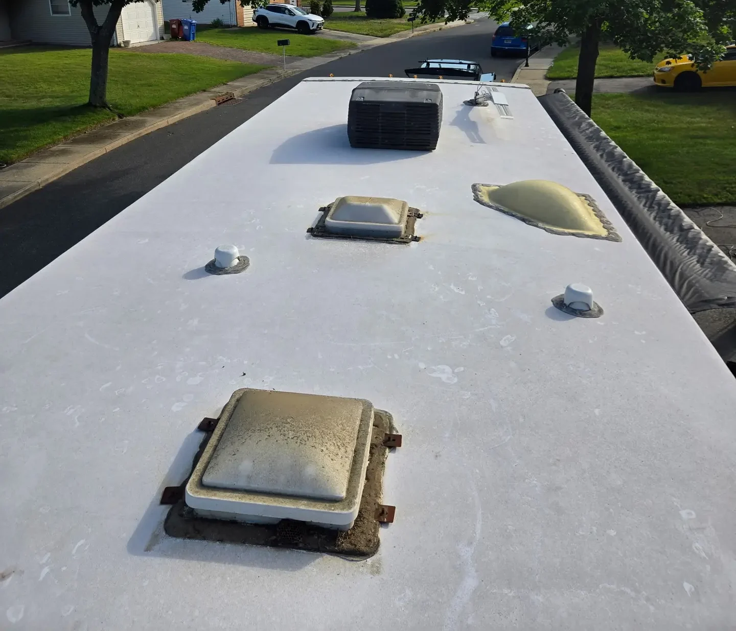 Weathered RV roof before mobile coating service